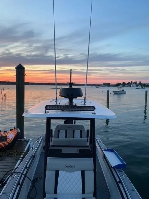 Slide: The Image of 1975 SeaCraft 23 Potter Hull boat docked at sunset, calm waters in the background. - 5