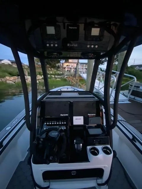 Slide: The Image of 1975 SeaCraft 23 Potter Hull boat cockpit with modern controls and scenic background. - 7