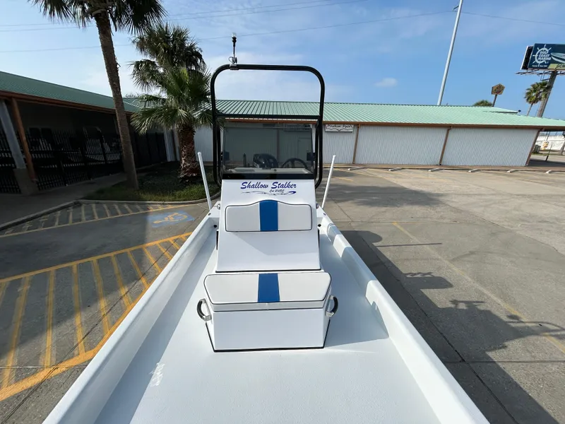 Slide: The Image of Shallow Stalker Cat 204 boat, 2025 model, parked outdoors on a sunny day. - 11