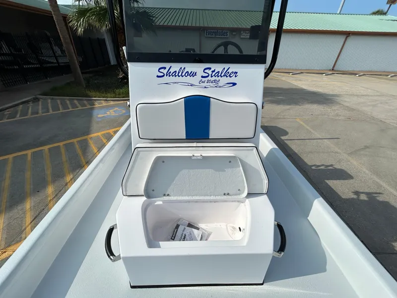 Slide: The Image of 2025 Shallow Stalker Cat 204 boat with open storage compartment on deck. - 12