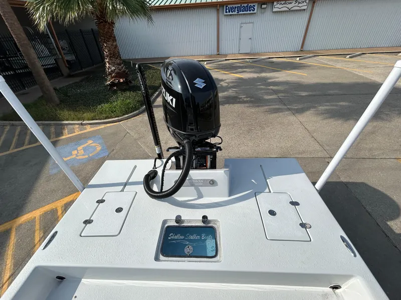 Slide: The Image of Shallow Stalker Cat 204 boat, 2025 model, with Suzuki outboard motor in parking lot. - 13