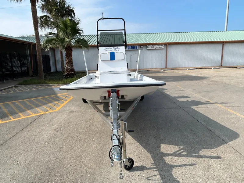 Slide: The Image of 2025 Shallow Stalker Cat 204 boat on trailer in parking lot. - 2