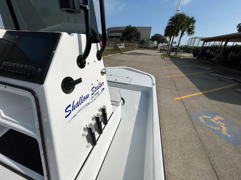 Slide: The Image of Shallow Stalker Cat 204 boat, 2025 model, parked near palm trees and handicap parking. - 7