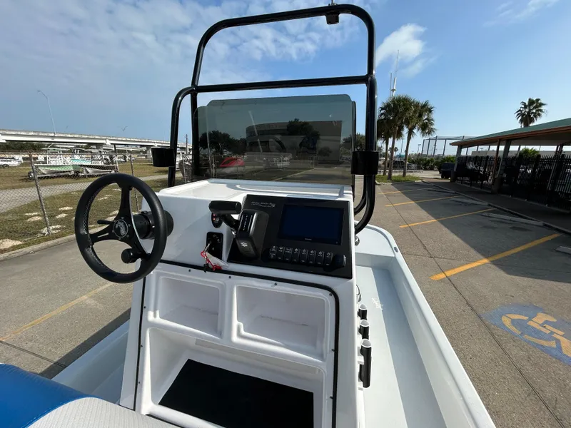 Slide: The Image of Shallow Stalker Cat 204 boat dashboard, 2025 model, with steering wheel and control panel. - 8