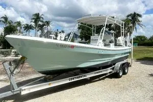 The Image of 2006 Andros Tarpon boat on trailer, parked outdoors under cloudy sky. - 1