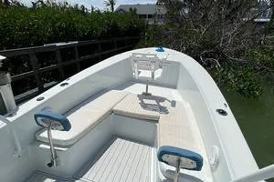 Slide: The Image of 2006 Andros Tarpon boat with seating, docked near lush greenery. - 11