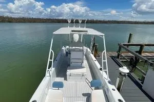 Slide: The Image of 2006 Andros Tarpon boat docked on calm water under a partly cloudy sky. - 12