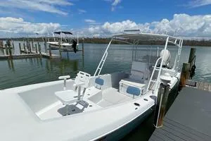 Slide: The Image of 2006 Andros Tarpon boat docked on a sunny day, calm waters in the background. - 5