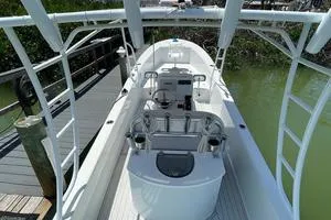 Slide: The Image of 2006 Andros Tarpon boat docked, featuring spacious deck and modern controls. - 7