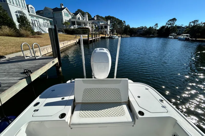 Slide: The Image of 2021 Caymas 28 HB boat docked by waterfront homes on a sunny day. - 10