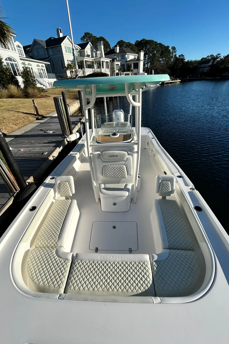 Slide: The Image of 2021 Caymas 28 HB boat docked by waterfront homes under clear blue sky. - 13