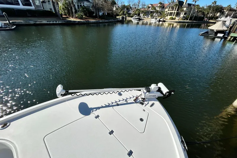 Slide: The Image of 2021 Caymas 28 HB boat on calm water with scenic waterfront view. - 18