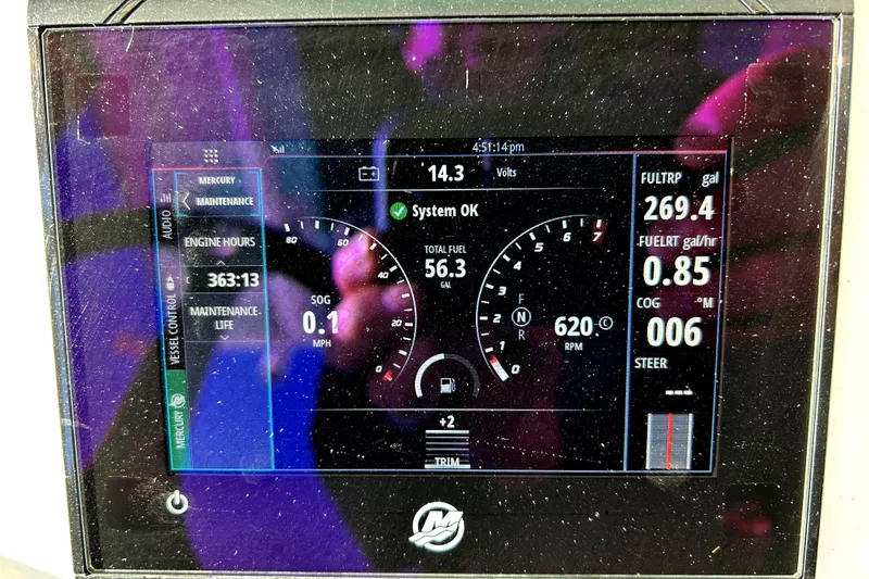 Slide: The Image of Dashboard display of a 2021 Caymas 28 HB boat showing engine metrics and system status. - 24