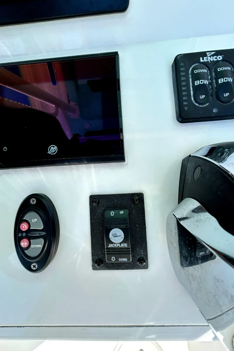 Slide: The Image of Control panel of a 2021 Caymas 28 HB boat with various switches and displays. - 26