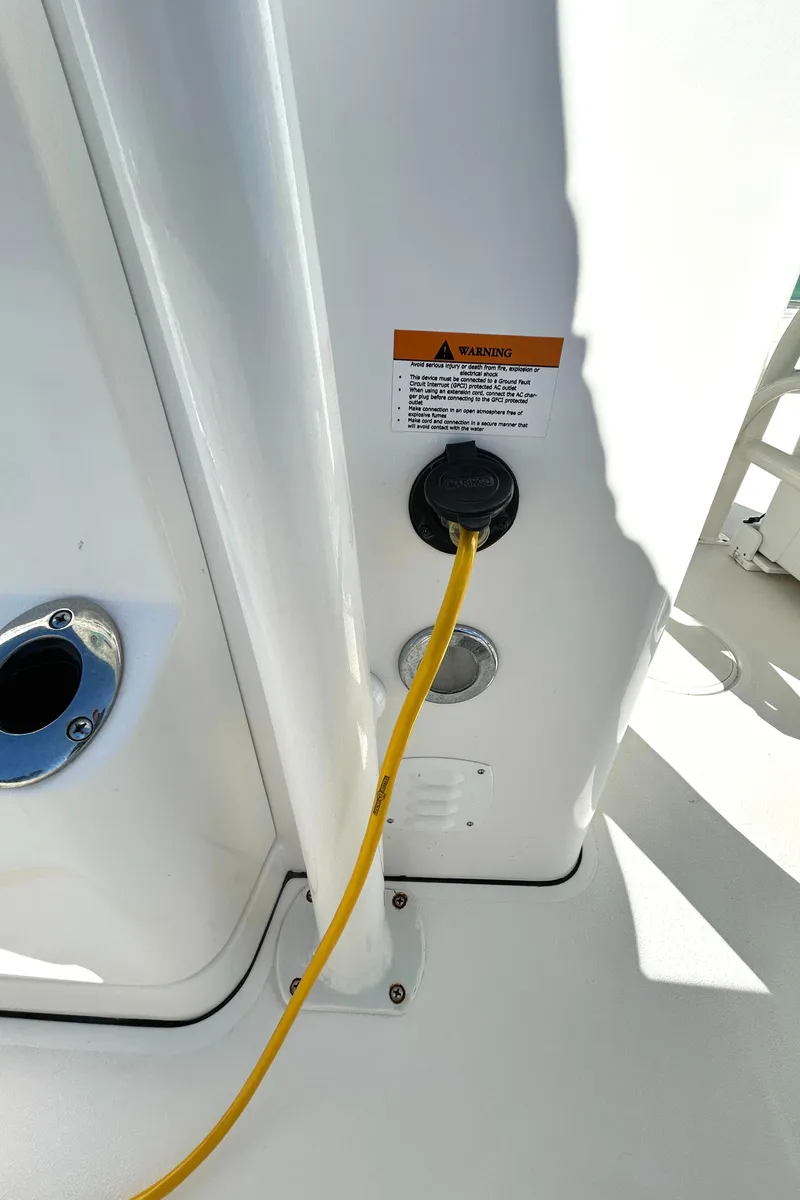 Slide: The Image of 2021 Caymas 28 HB boat with yellow power cable connection. - 31