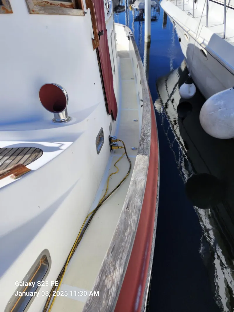 Slide: The Image of 1988 Lord Nelson Victory 37 docked, showing deck and mooring details. - 10