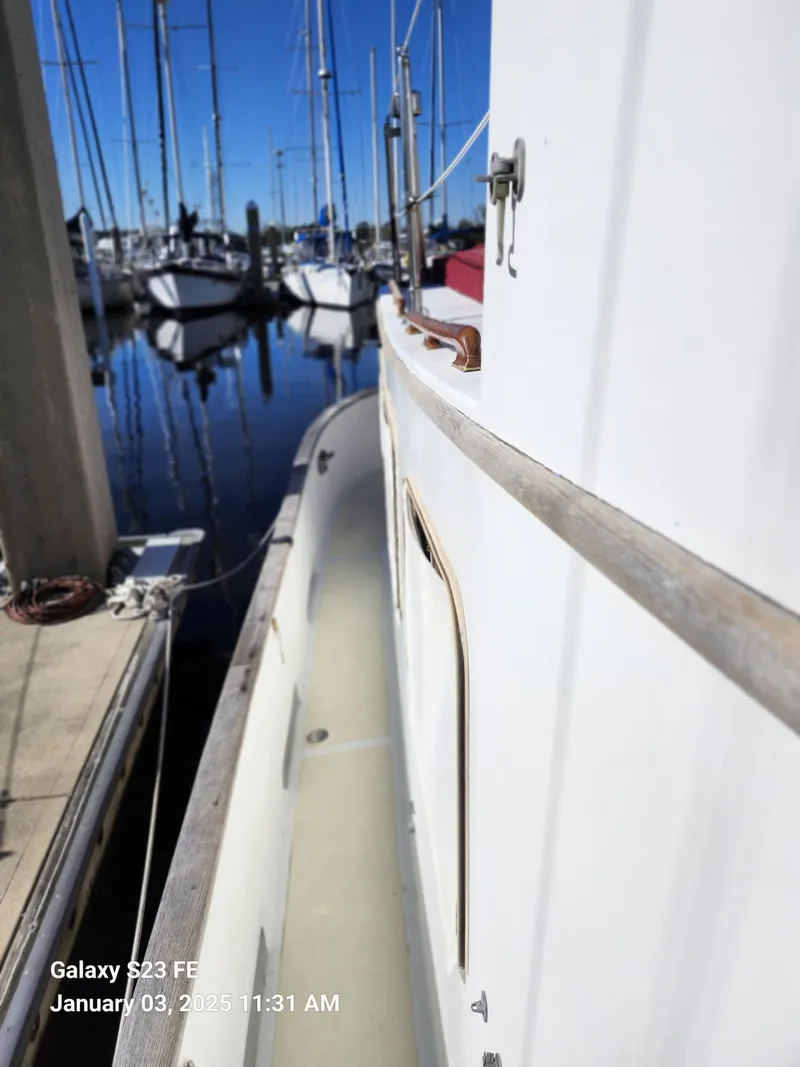 Slide: The Image of Side view of 1988 Lord Nelson Victory 37 yacht docked at marina. - 11