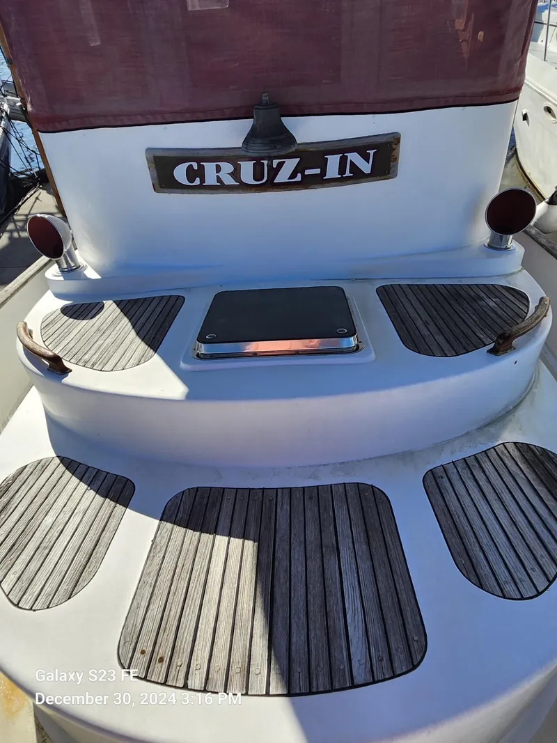 Slide: The Image of 1988 Lord Nelson Victory 37 yacht with "CRUZ-IN" nameplate, wooden deck details. - 12