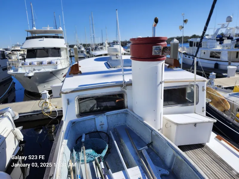 Slide: The Image of 1988 Lord Nelson Victory 37 yacht docked in a marina, surrounded by other boats. - 19