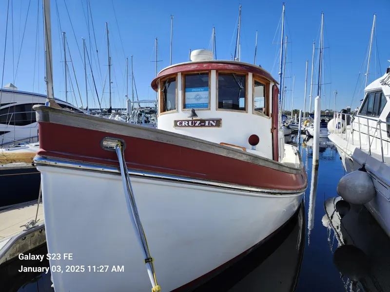 Slide: The Image of 1988 Lord Nelson Victory 37 boat docked in marina, clear blue sky. - 2