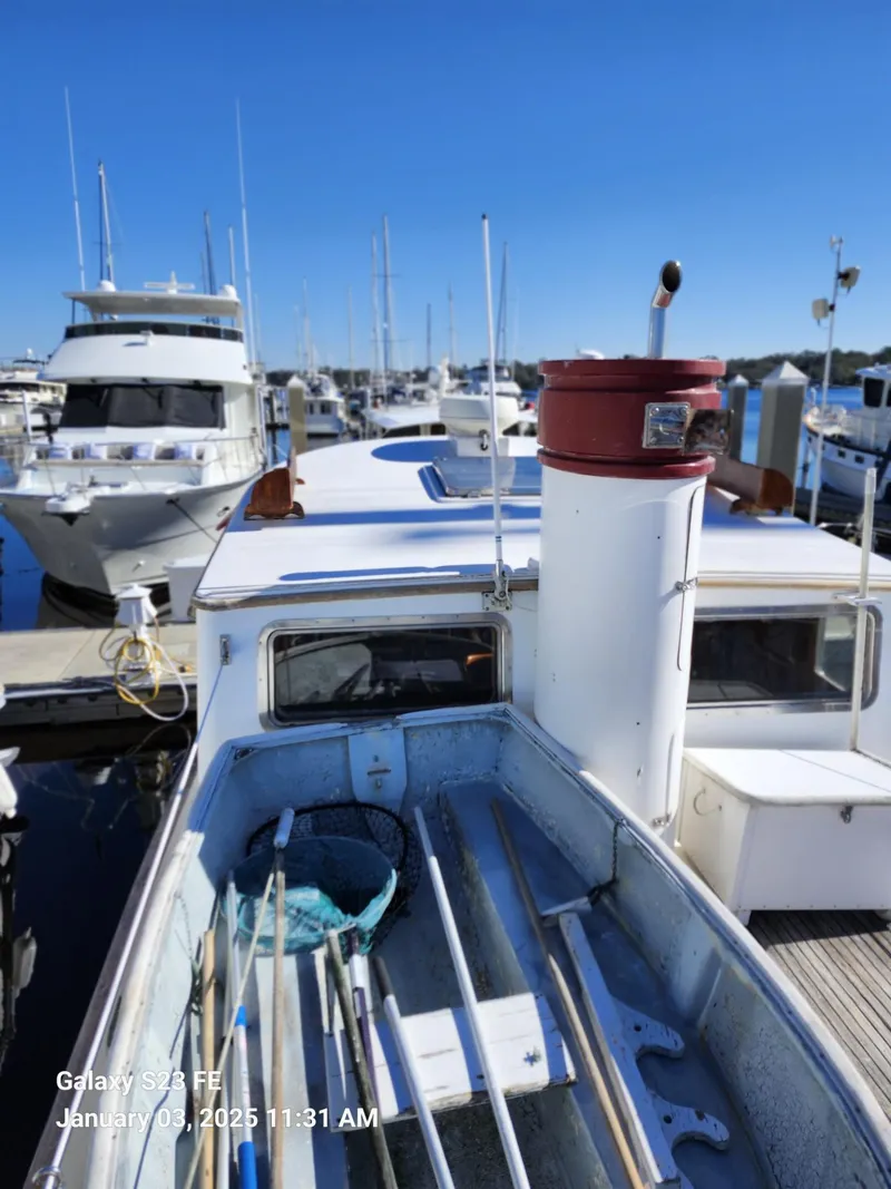 Slide: The Image of 1988 Lord Nelson Victory 37 boat docked at marina under clear blue sky. - 21