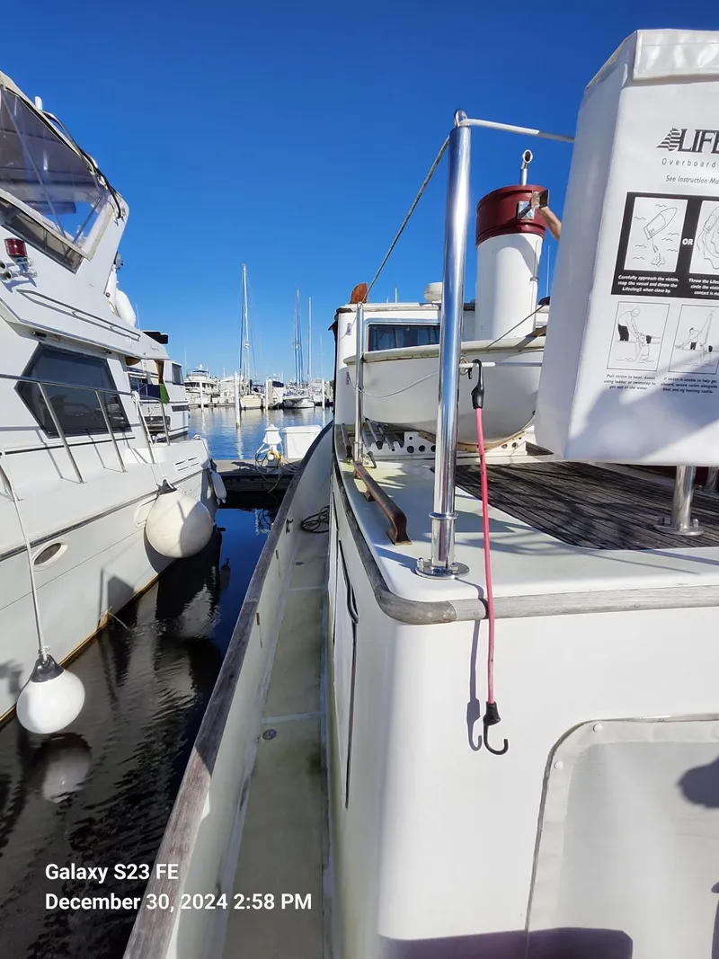 Slide: The Image of 1988 Lord Nelson Victory 37 yacht docked at marina under clear blue sky. - 24