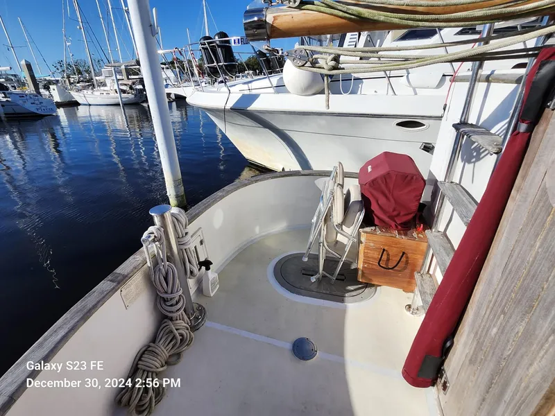Slide: The Image of 1988 Lord Nelson Victory 37 sailboat docked in marina, featuring deck and rigging. - 25