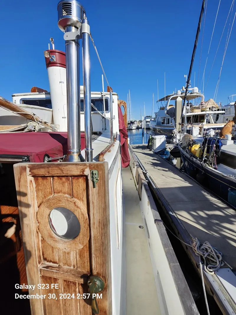 Slide: The Image of 1988 Lord Nelson Victory 37 yacht docked in marina, clear blue sky. - 26