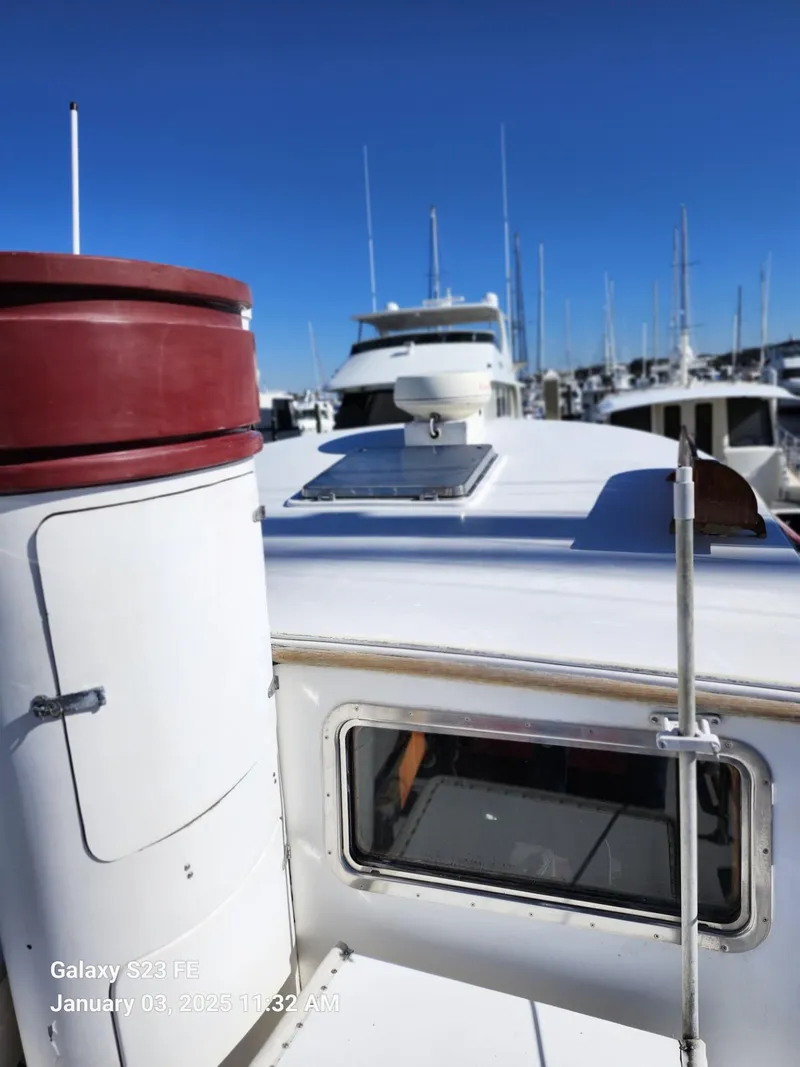 Slide: The Image of 1988 Lord Nelson Victory 37 yacht docked in marina under clear blue sky. - 28
