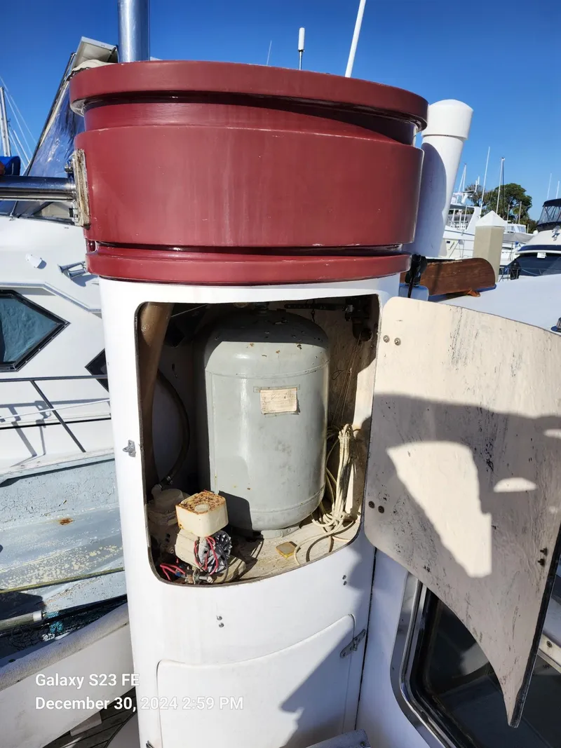 Slide: The Image of Electrical compartment on 1988 Lord Nelson Victory 37 boat, open panel, marina background. - 29