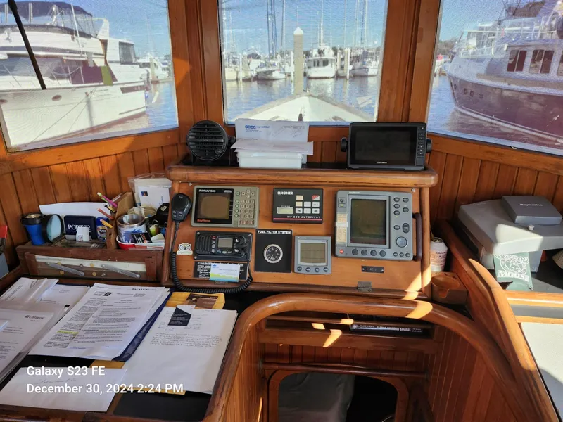 Slide: The Image of Interior of 1988 Lord Nelson Victory 37 boat with navigation equipment and marina view. - 30