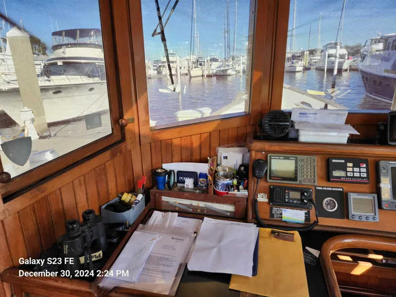 Slide: The Image of Interior of 1988 Lord Nelson Victory 37 boat with navigation equipment and marina view. - 31