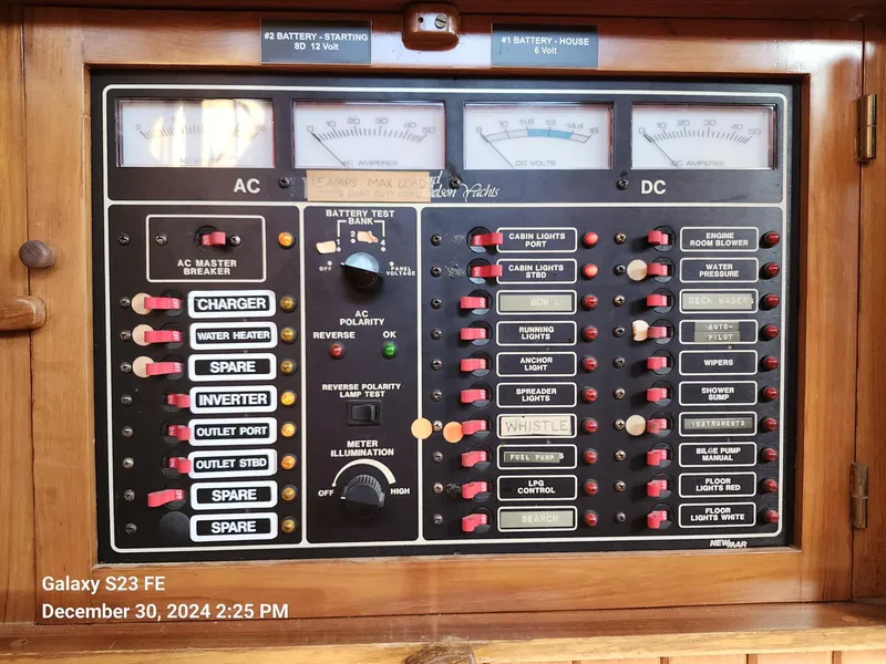 Slide: The Image of Electrical control panel of a 1988 Lord Nelson Victory 37 boat, featuring AC and DC switches. - 34