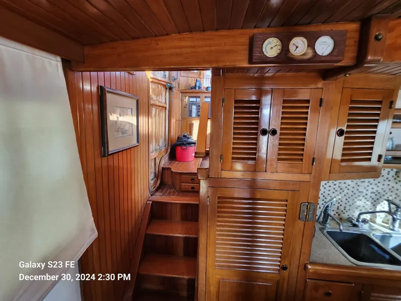 Slide: The Image of Interior of 1988 Lord Nelson Victory 37 yacht with wooden cabinetry and stairs. - 36