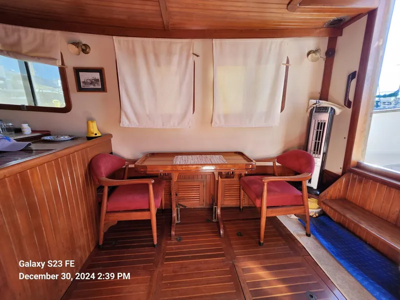 Slide: The Image of Cozy cabin interior of 1988 Lord Nelson Victory 37 yacht with wooden decor and seating. - 44