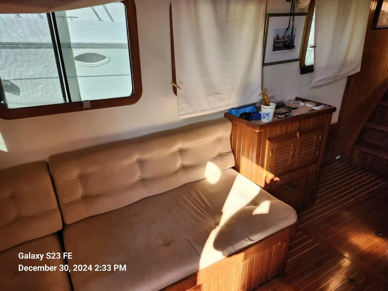 Slide: The Image of Cozy interior of 1988 Lord Nelson Victory 37 yacht with wooden furniture and beige sofa. - 45