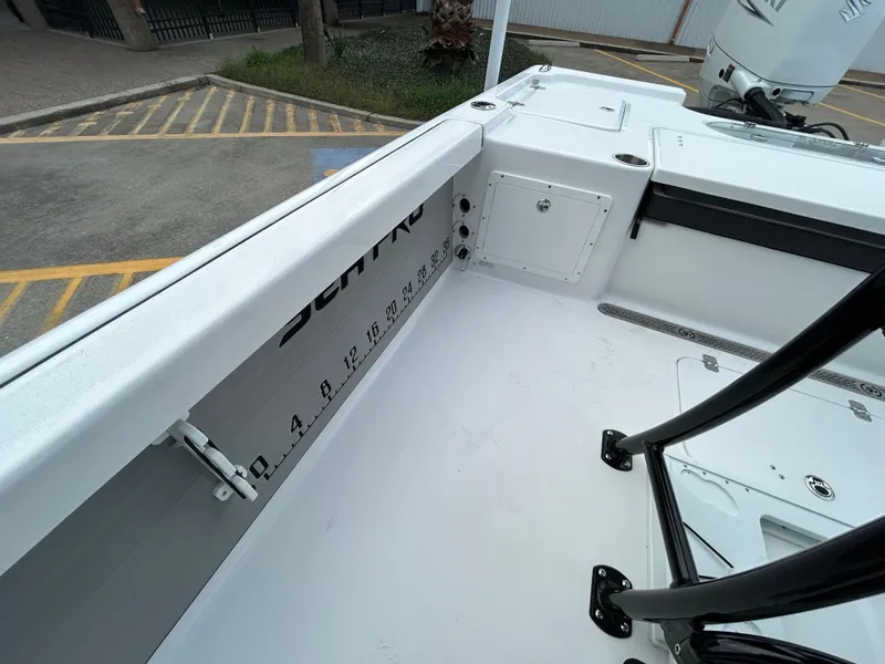 Slide: The Image of 2024 Sea Pro 250 DLX boat interior with measurement markings and storage compartments. - 11