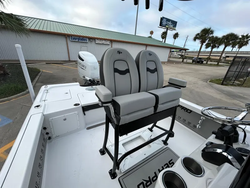 Slide: The Image of 2024 Sea Pro 250 DLX boat interior with dual seats and steering console. - 15