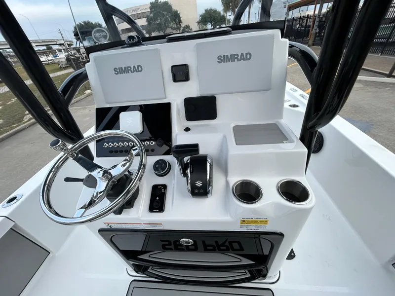 Slide: The Image of 2024 Sea Pro 250 DLX boat console with Simrad electronics and steering wheel. - 16