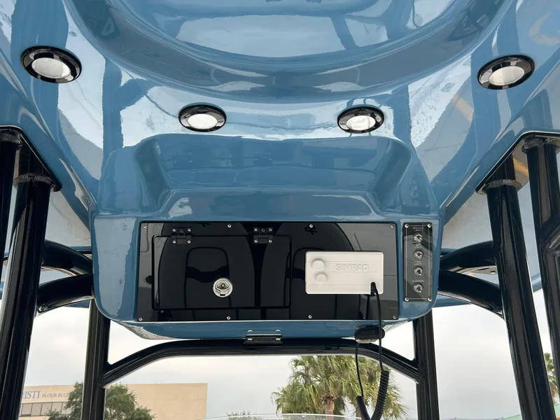 Slide: The Image of 2024 Sea Pro 250 DLX boat console with blue finish and integrated lighting. - 19