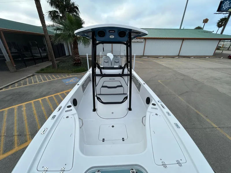Slide: The Image of 2024 Sea Pro 250 DLX boat, white interior, parked outdoors. - 23