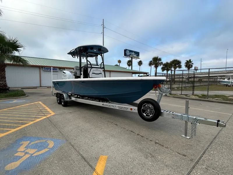 Slide: The Image of 2024 Sea Pro 250 DLX boat on trailer in parking lot, palm trees in background. - 3