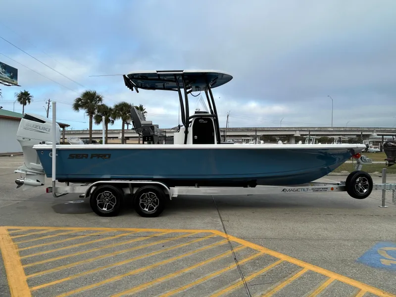Slide: The Image of 2024 Sea Pro 250 DLX boat on trailer, parked outdoors. - 4