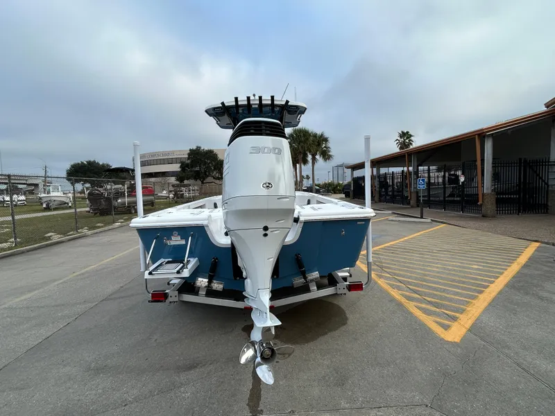 Slide: The Image of 2024 Sea Pro 250 DLX boat, rear view, parked on a trailer in a lot. - 6