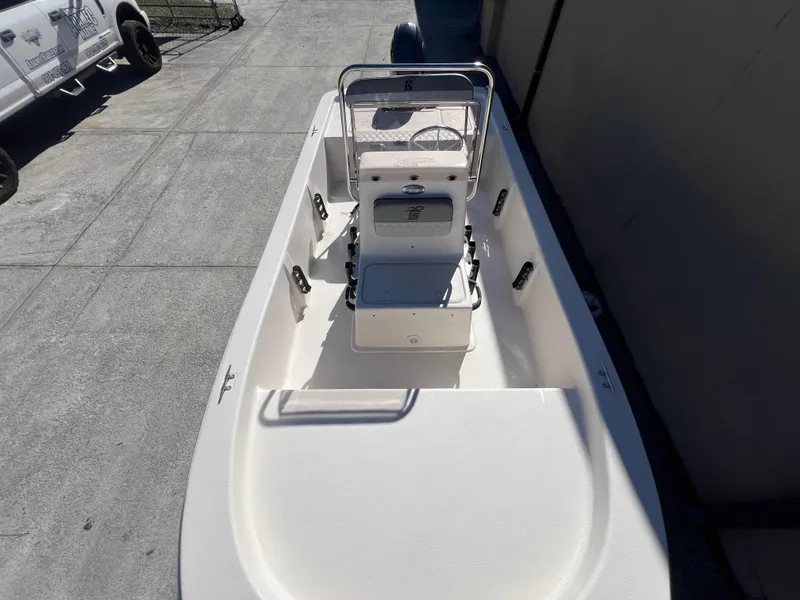 Slide: The Image of 2025 Carolina Skiff E 16 JVX boat, white interior, docked outdoors. - 14