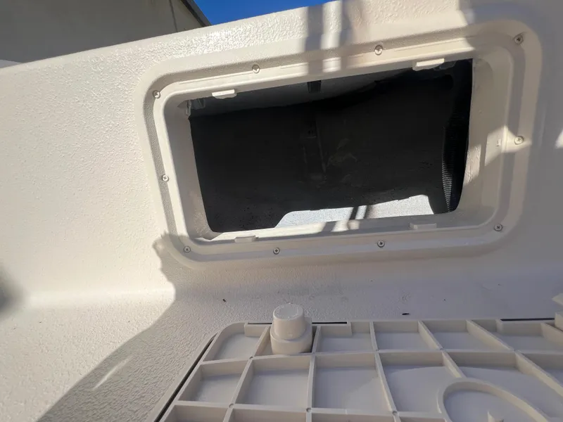 Slide: The Image of 2025 Carolina Skiff E 16 JVX boat interior detail with storage compartment. - 17