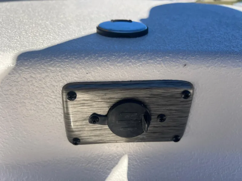 Slide: The Image of 2025 Carolina Skiff E 16 JVX boat detail, featuring a mounted electrical outlet. - 19