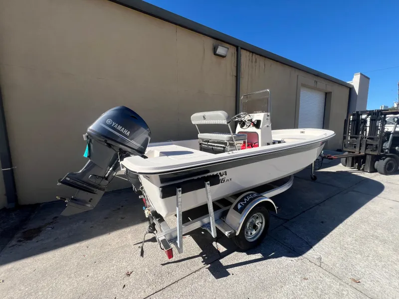 Slide: The Image of 2025 Carolina Skiff E 16 JVX boat with Yamaha motor on trailer. - 2