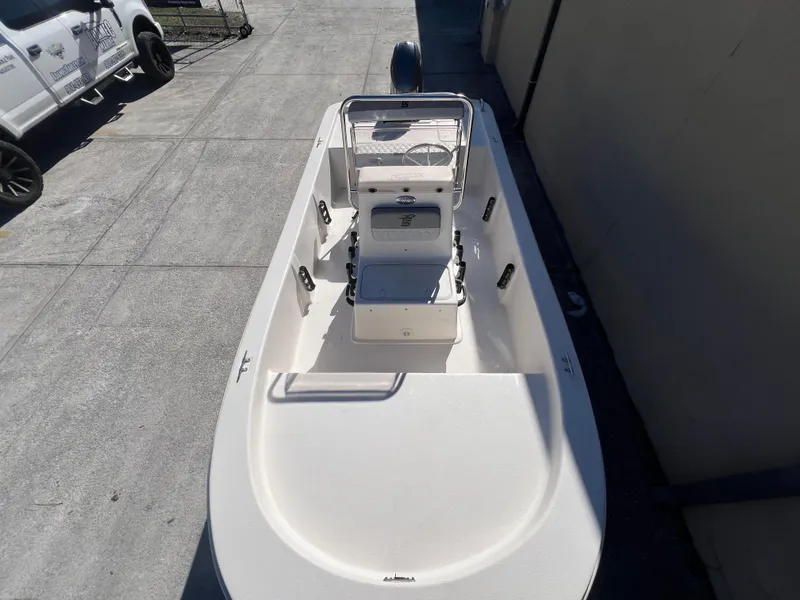 Slide: The Image of 2025 Carolina Skiff E 16 JVX boat, top view, parked on concrete surface. - 20