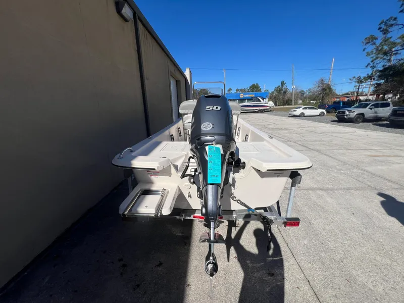 Slide: The Image of 2025 Carolina Skiff E 16 JVX boat with outboard motor in a parking lot. - 3